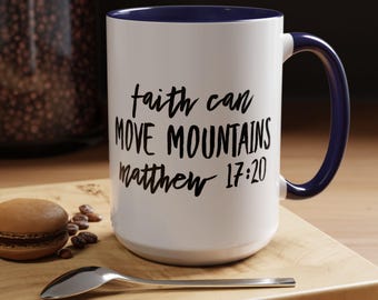May include: White ceramic mug with a blue rim and handle. The mug has black text that reads "faith can move mountains matthew 17:20".