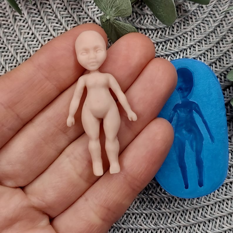 May include: A nude-coloured silicone doll mould with a small, nude-coloured doll made from the mould. The doll is approximately 10 cm tall and has a simple, realistic design.