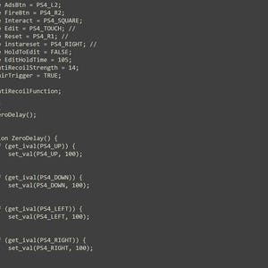May include: A dark gray computer screen displaying lines of programming code. The text includes definitions for controller buttons like AdsBtn, FireBtn, and Interact, followed by a main function and a ZeroDelay function with conditional statements.