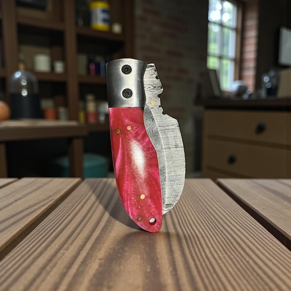 Damascus Steel Folding Knife, 7 1/4” Overall Length when extended, Copper Tooling, Pink Handle, Leather Sheath. Can be used as pocket knife.