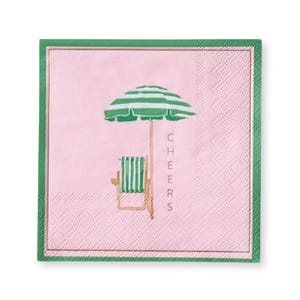 May include: A pink square paper napkin with a green border and gold trim. The napkin features a beach scene with a green and white striped umbrella, a matching chair, and the word "CHEERS" in gold.