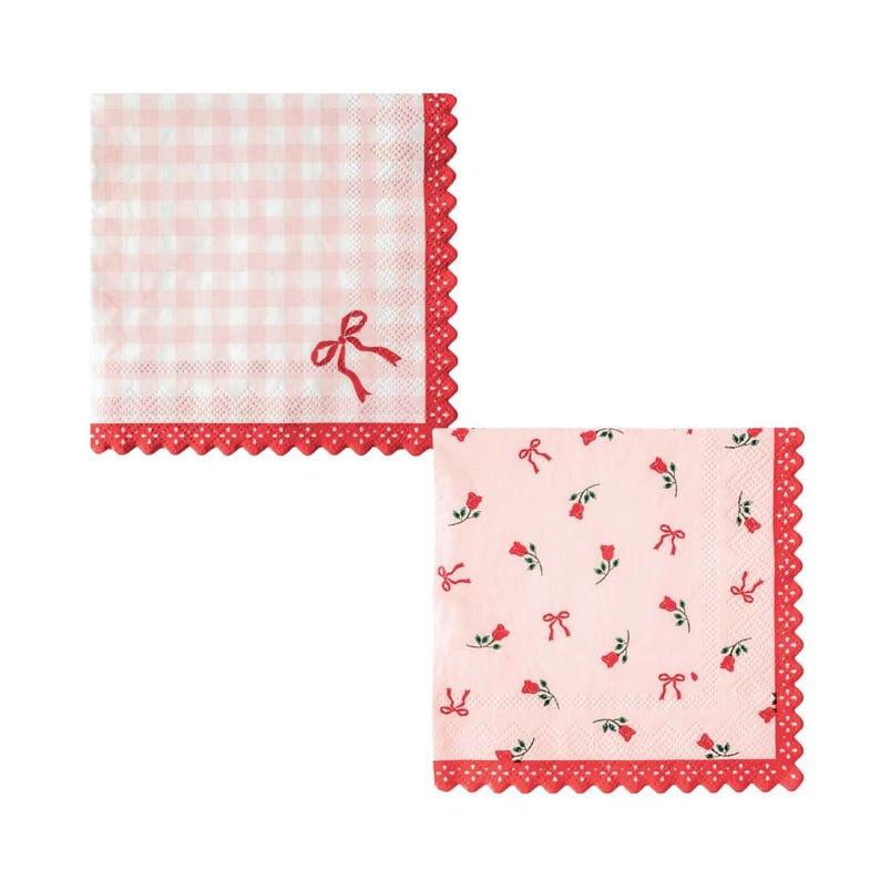 May include: Two pink paper napkins with red scalloped edges. One napkin has a pink and white gingham pattern with a red bow. The other napkin has a pink background with red bows and red flowers.