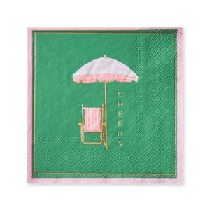 May include: Square green paper napkin with a pink border and a gold trim. The napkin features a beach scene with a pink and white striped umbrella, a pink and white striped beach chair, and the word "CHEERS" in gold.
