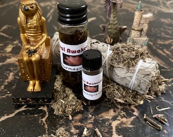 May include: Two small bottles of essential oil with labels that read "Spiritual Awakening" and "Spiritual Awakening" with a white sage smudge stick and a gold statue of an Egyptian deity.