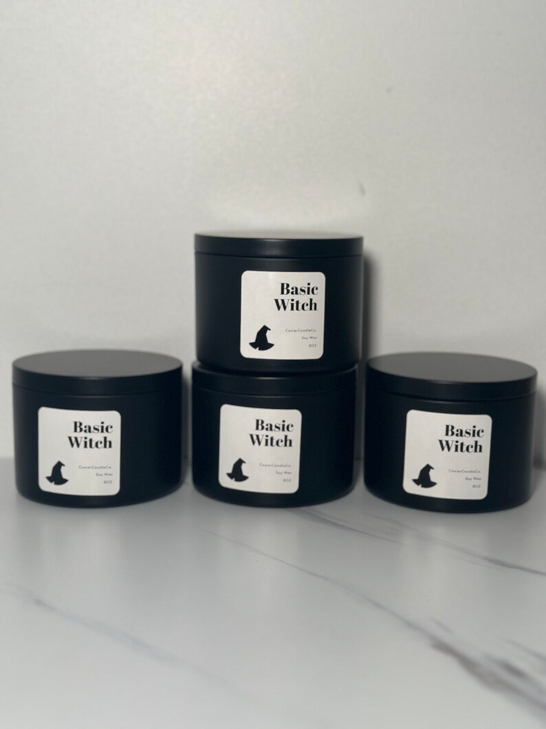 May include: Three black candle jars with white labels that say "Basic Witch" and a witch's hat graphic.