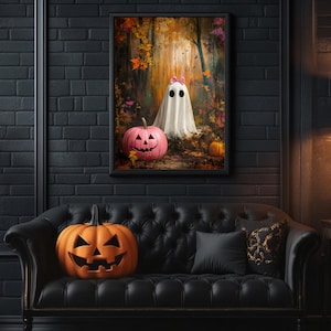 May include: A black leather sofa with a black cushion and a carved wooden frame. A carved pumpkin sits on the sofa. A framed print of a ghost with pink bows and a pumpkin in a woodland setting hangs on the wall behind the sofa.