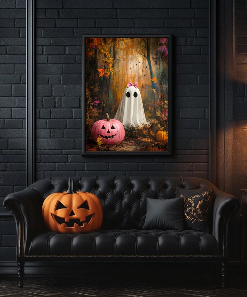 May include: A black leather sofa with a black cushion and a carved wooden frame. A carved pumpkin sits on the sofa. A framed print of a ghost with pink bows and a pumpkin in a woodland setting hangs on the wall behind the sofa.