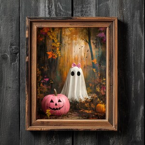 May include: A framed painting depicting a white ghost wearing a pink bow in a woodland scene. A pink jack-o'-lantern is in the foreground.