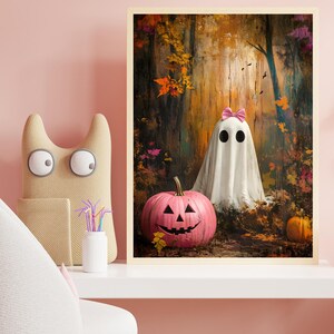 May include: A pink jack-o'-lantern with a friendly face sits in front of a white ghost wearing a pink bow in an autumn woodland setting.