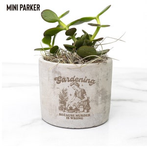 May include: A small concrete planter with a succulent plant and the text "Gardening because murder is wrong".
