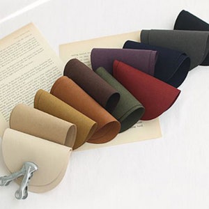 May include: A set of ten half-circle fabric pieces in various shades of brown, beige, and grey. The fabric pieces are arranged in a fan shape, with the lightest colour at the bottom and the darkest colour at the top.