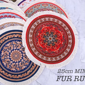 May include: A set of four round, patterned rugs with fringed edges. The rugs are in various colours and designs, including red, blue, and white. The largest rug is 25 cm in diameter and is labelled "25cm MINI FUR RUG".