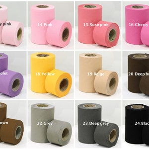 May include: Assortment of 12 rolls of felt fabric in various colors, including baby pink, pink, rose pink, cherry pink, violet, yellow, beige, deep brown, brown, grey, deep grey, and black. Each roll is labeled with a number and color name.