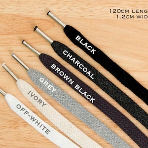 May include: Six different colors of shoelaces, 120 cm long and 1.2 cm wide. The colors are off-white, ivory, grey, brown black, charcoal, and black.
