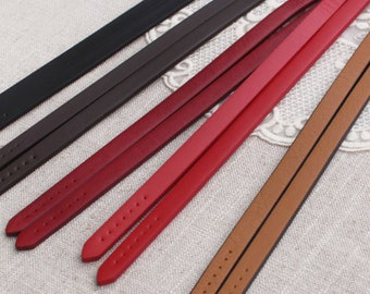 May include: Five leather straps in different colors: black, brown, burgundy, red, and tan. The straps are all the same width and have a textured surface with small holes.