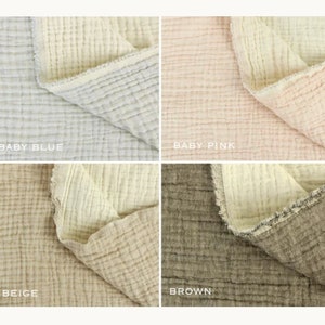 May include: Four fabric swatches in different colors: baby blue, baby pink, beige, and brown. Each swatch is folded in half to show the texture of the fabric.