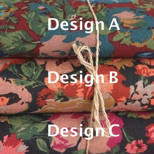 May include: Three fabric swatches with floral patterns. The top swatch is red with blue and green flowers. The middle swatch is black with red, orange, and yellow flowers. The bottom swatch is black with pink, red, and green flowers. The swatches are labeled "Design A", "Design B", and "Design C".
