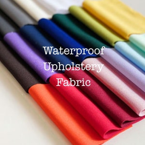 May include: A variety of colors of waterproof upholstery fabric swatches. The swatches are arranged in a fan shape, with the text "Waterproof Upholstery Fabric" in the center.