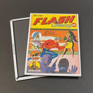 May include: A vintage comic book cover featuring The Flash, a superhero with red and yellow costume, running with a red beam of light. The cover is titled "Flash Comics" and features the text "Introducing The Flash - Fastest man alive!"