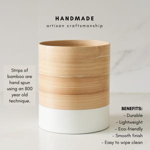May include: A handmade bamboo utensil holder with a white base. The holder is made from strips of bamboo that are hand spun using an 800-year-old technique. The text "HANDMADE artisan craftsmanship" is at the top of the image. The text "BENEFITS: - Durable - Lightweight - Eco-friendly - Smooth finish - Easy to wipe clean" is at the bottom of the image.