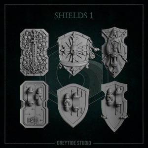 Könnte beinhalten: Sechs verschiedene Schilddesigns, alle in grauer Farbe. Die Schilde sind alle in verschiedenen Formen und Größen und haben alle unterschiedliche Details. Die Schilde sind mit "SHIELDS 1" und "GREYTIDE STUDIO" beschriftet.