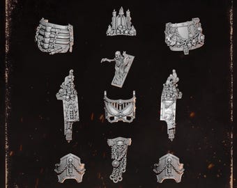 Può includere: Una collezione di componenti per armature in miniatura in resina grigia etichettati ANCIENT ARMOR, caratterizzati da intricati motivi a teschio, catene, figure scheletriche e dettagli architettonici gotici per miniature da gioco.