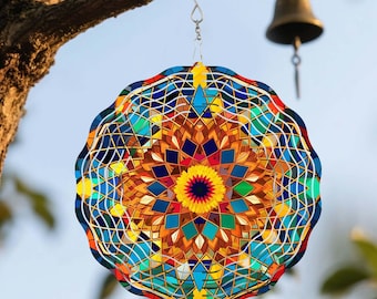 May include: A colorful, round wind spinner with a mosaic-like design, hanging from a tree branch. The spinner features a vibrant array of colors including blue, yellow, orange, and green. A small bell hangs in the background.