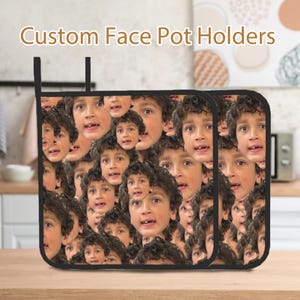 May include: Two black pot holders with a pattern of a young boy's face repeated across the surface. The text "Custom Face Pot Holders" is displayed at the top of the image.