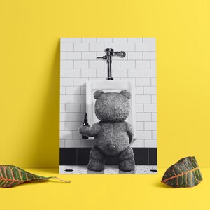 Playful bathroom decor print with a bear character standing at a urinal in a modern interior.