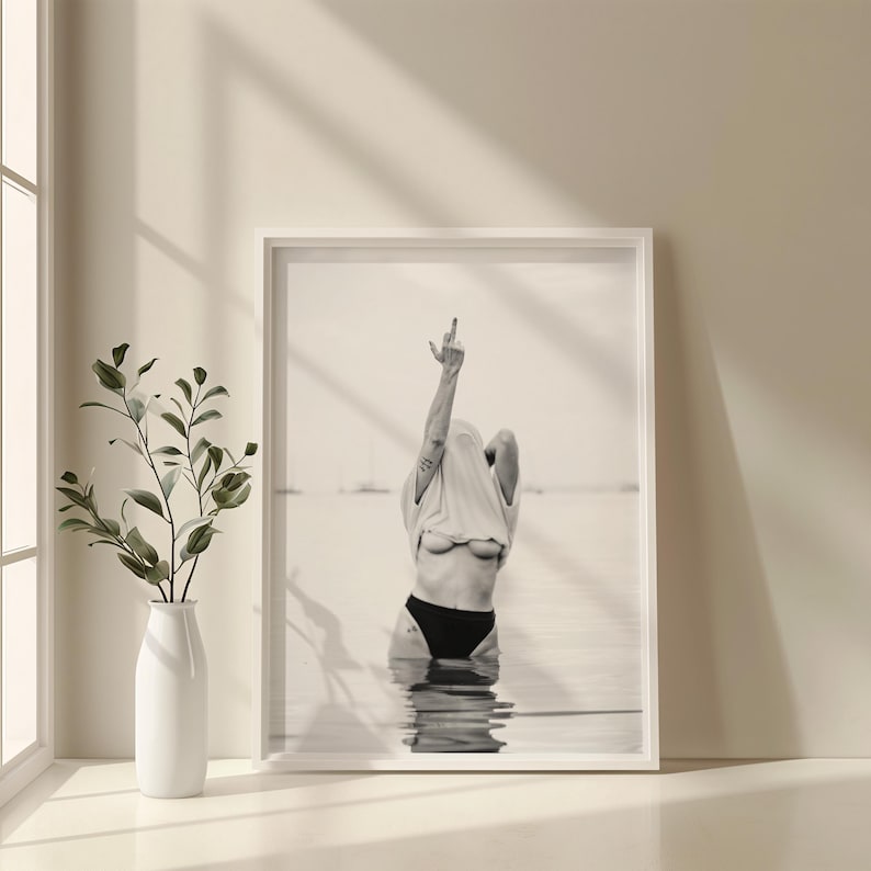 Striking black and white photography print featuring rebellious feminine energy. A bold and edgy feminist art piece, perfect for modern wall decor. Unique aesthetic gift for her, ideal for home, bedroom, or office. High-quality minimalist artwork for those who embrace fearless expression.