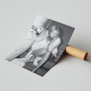 Vintage Kate Moss canvas poster featuring her iconic smoking on stairs pose. A perfect addition to any 90s fashion lover's decor, black and white photography style for a retro, chic vibe. Ideal for celebrity wall art enthusiasts and retro home decor.