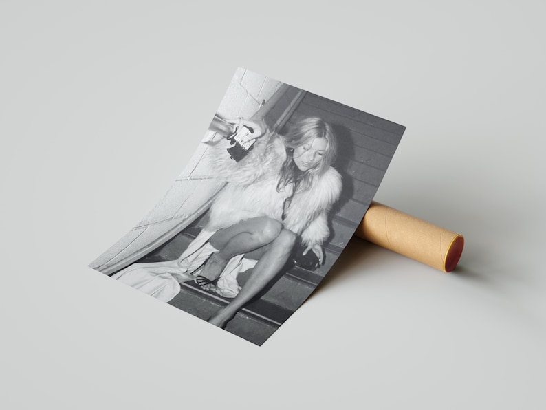 Vintage Kate Moss canvas poster featuring her iconic smoking on stairs pose. A perfect addition to any 90s fashion lover's decor, black and white photography style for a retro, chic vibe. Ideal for celebrity wall art enthusiasts and retro home decor.