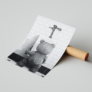 Novelty bathroom wall decor showcasing a teddy bear in a lighthearted and irreverent scene.