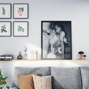 Vintage Kate Moss canvas poster featuring her iconic smoking on stairs pose. A perfect addition to any 90s fashion lover's decor, black and white photography style for a retro, chic vibe. Ideal for celebrity wall art enthusiasts and retro home decor.