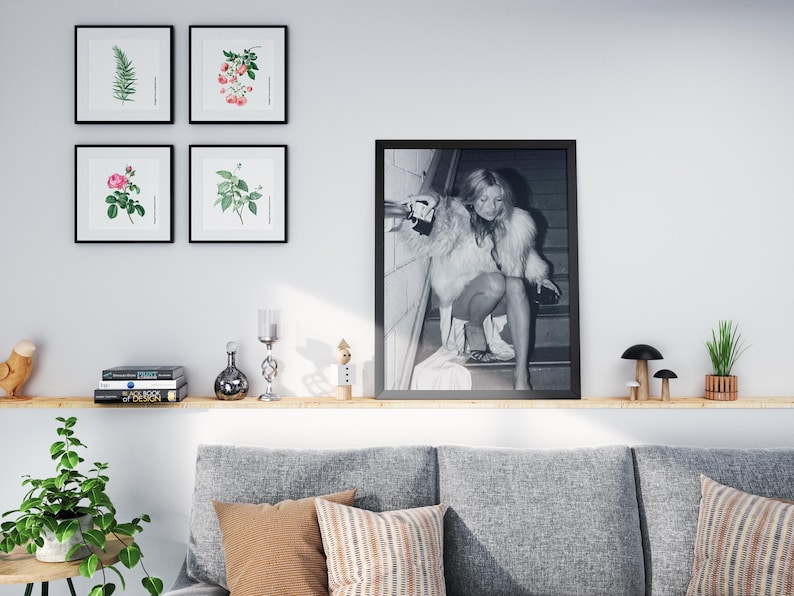 Vintage Kate Moss canvas poster featuring her iconic smoking on stairs pose. A perfect addition to any 90s fashion lover's decor, black and white photography style for a retro, chic vibe. Ideal for celebrity wall art enthusiasts and retro home decor.