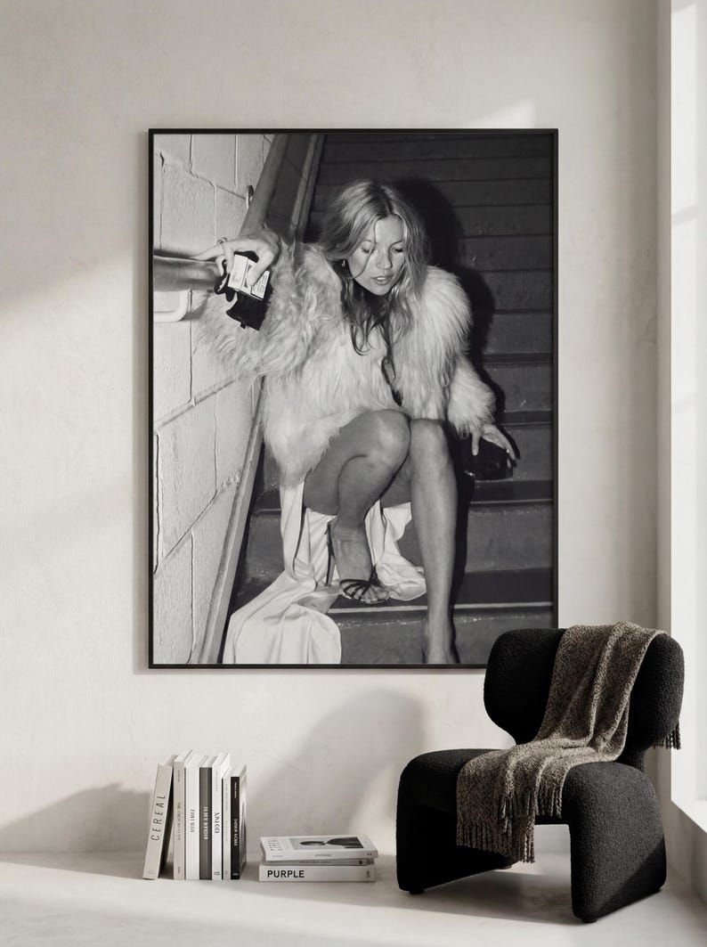 Vintage Kate Moss canvas poster featuring her iconic smoking on stairs pose. A perfect addition to any 90s fashion lover's decor, black and white photography style for a retro, chic vibe. Ideal for celebrity wall art enthusiasts and retro home decor.