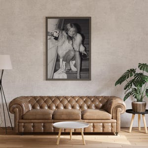 Vintage Kate Moss canvas poster featuring her iconic smoking on stairs pose. A perfect addition to any 90s fashion lover's decor, black and white photography style for a retro, chic vibe. Ideal for celebrity wall art enthusiasts and retro home decor.