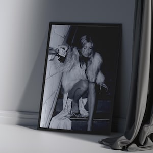 Vintage Kate Moss canvas poster featuring her iconic smoking on stairs pose. A perfect addition to any 90s fashion lover's decor, black and white photography style for a retro, chic vibe. Ideal for celebrity wall art enthusiasts and retro home decor.