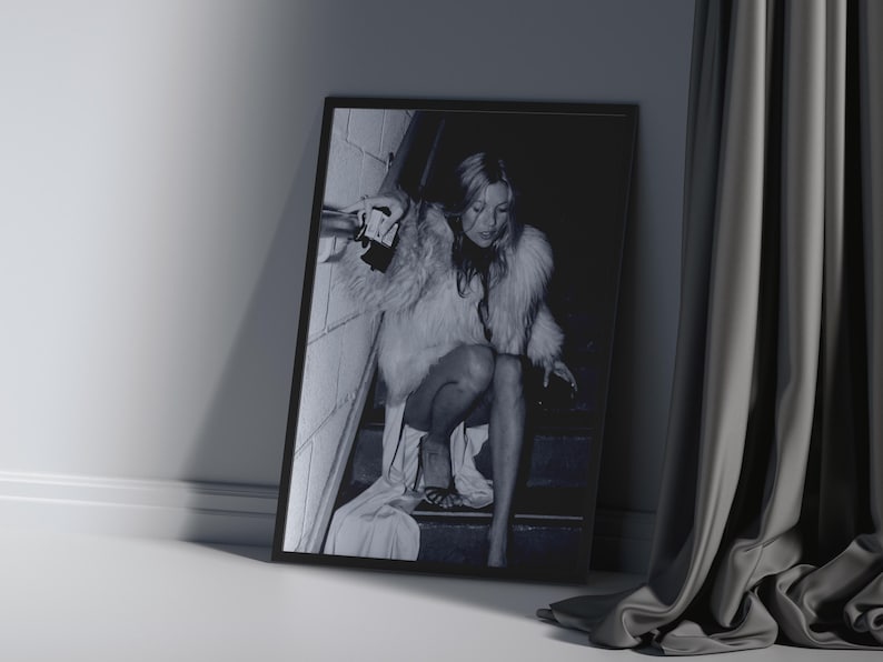 Vintage Kate Moss canvas poster featuring her iconic smoking on stairs pose. A perfect addition to any 90s fashion lover's decor, black and white photography style for a retro, chic vibe. Ideal for celebrity wall art enthusiasts and retro home decor.