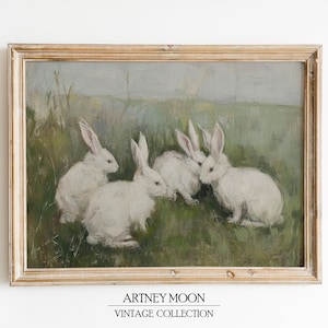 May include: A vintage framed painting of four white rabbits in a field. The rabbits are sitting in a grassy field with a light blue sky in the background.
