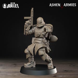 May include: A detailed, gray miniature figure of a soldier in full armor, holding a gun and pointing. The figure is on a black base. The text "Bite the Bullet" and "Ashen Armies" are visible.