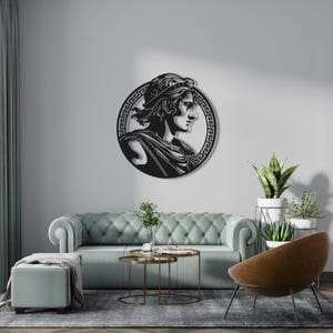 May include: Black metal wall art featuring a profile of a person wearing a crown and a patterned robe, surrounded by a Greek key border.