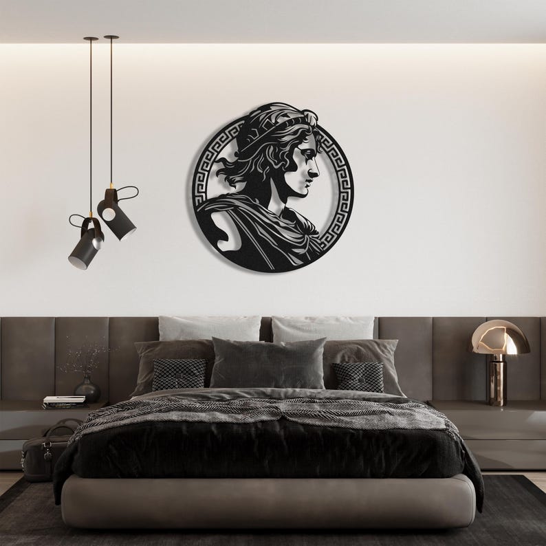 May include: Black metal wall art featuring a profile of a person wearing a crown and a Greek key border.