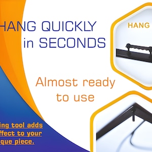 May include: A black metal hanging tool with a hook on the end. The tool is designed to hang pictures or other objects quickly and easily. The text "HANG QUICKLY in SECONDS" and "HANG HERE" is visible in the image.