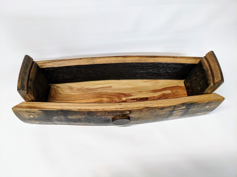 May include: A wooden rectangular box made from reclaimed wine barrel staves. The box is open and the inside is lined with light wood. The box has a dark brown stain and brass accents.