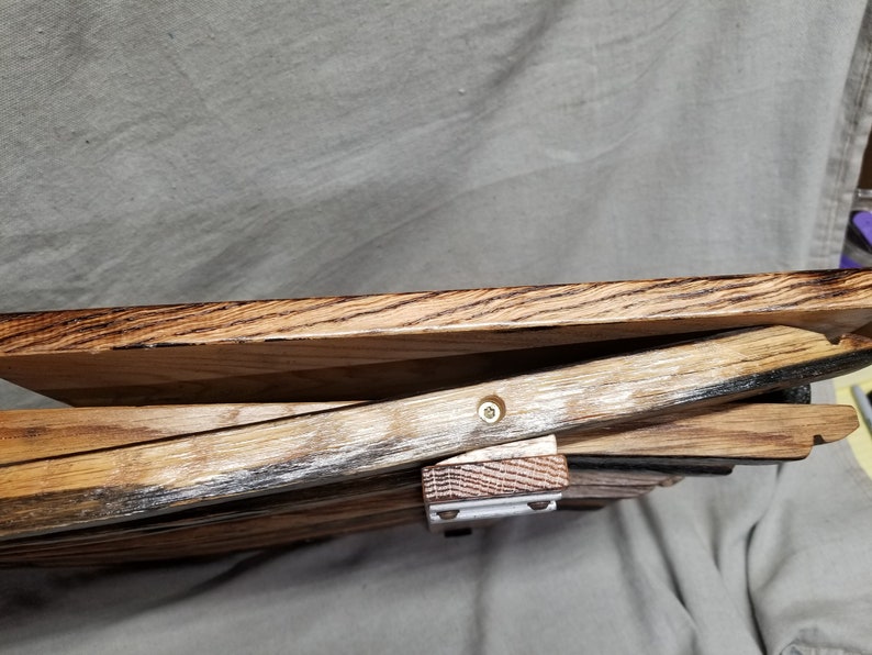 K&ouml;nnte beinhalten: Ein Tablett aus wiederverwendetem Holz. Das Tablett besteht aus mehreren zusammengef&uuml;gten Holzst&uuml;cken. Das Holz hat eine nat&uuml;rliche braune Farbe mit dunkelbraunen Streifen. Das Tablett ist etwa 30 cm breit und 46 cm lang.