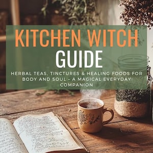May include: A rustic wooden table displays an open book, a steaming mug, and a jar. The text "KITCHEN WITCH GUIDE" is overlaid on the image, with the subtitle "HERBAL TEAS, TINCTURES & HEALING FOODS FOR BODY AND SOUL - A MAGICAL EVERYDAY COMPANION".