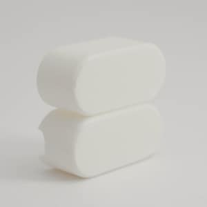 May include: Two white, rectangular objects with rounded edges are stacked. The top object is complete, while the bottom has a small notch. The objects are set against a white background. The objects appear to be made of a solid material.