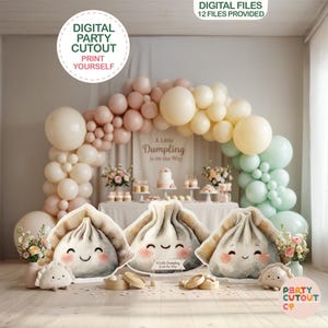 May include: A party decoration set with a dumpling theme. The scene includes large dumpling cutouts, a balloon arch in pastel colors, and a table with desserts. Text on the cutouts reads "A Little Dumpling is on the Way."