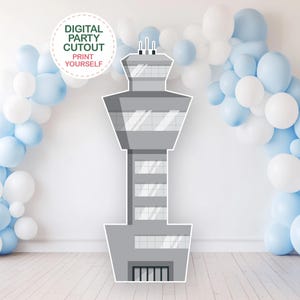 May include: A gray airport control tower cutout with a white and light blue balloon arch. The cutout has a detailed design with windows and doors. Text on the image reads "DIGITAL PARTY CUTOUT PRINT YOURSELF".